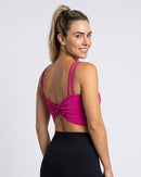 Top Fitness Costas Nó rosa de costas, com o nó e as alças duplas (imagem criada com IA)